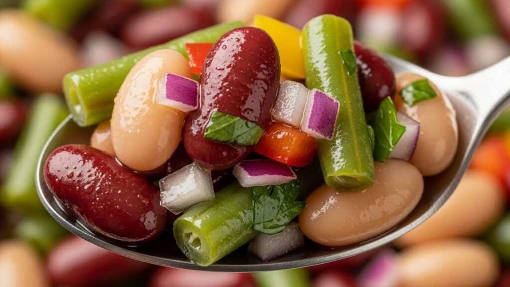 Close-up of spoon scooping 3-bean salad
