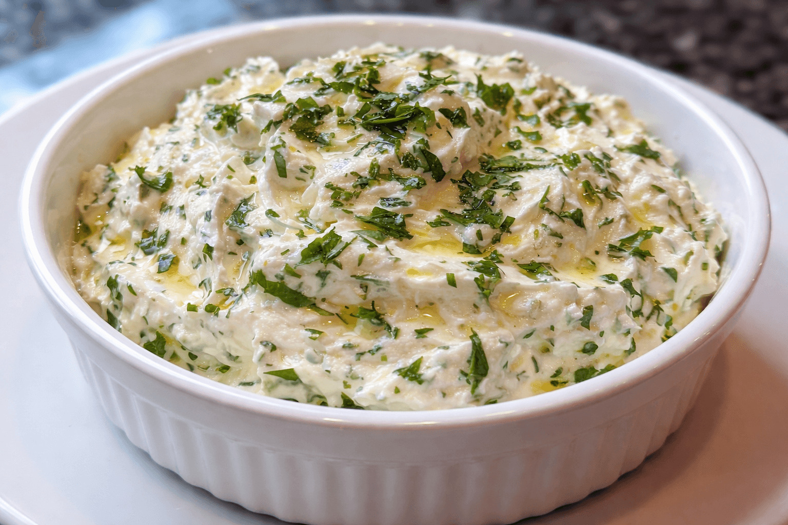 Whipped garlic and herb cottage cheese dip served with pita chips.