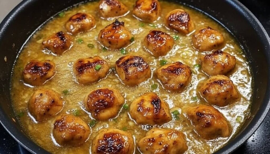 One-pan chicken and rice simmering in a skillet with broth.