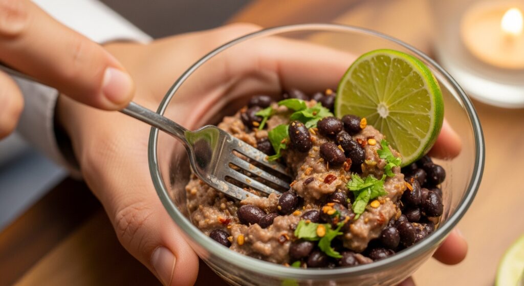 Mashing seasoned black beans for quesadilla filling.