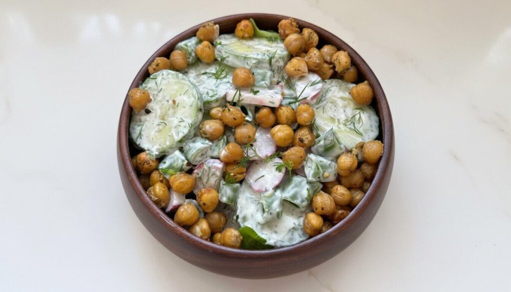 Tzatziki Chickpea Salad in a wooden bowl with roasted chickpeas and cucumbers.