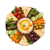Mediterranean mezze platter in circular format with hummus, vegetables, olives and pita bread